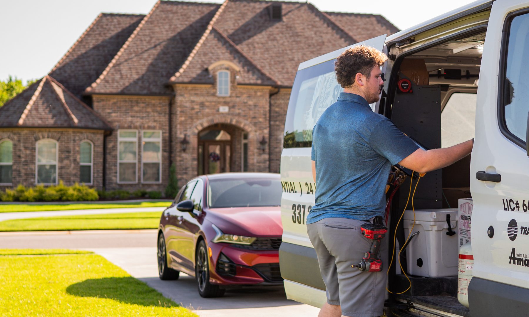 Superior Heating & Cooling technician working out of a service van parked at a customer's home in Lafayette